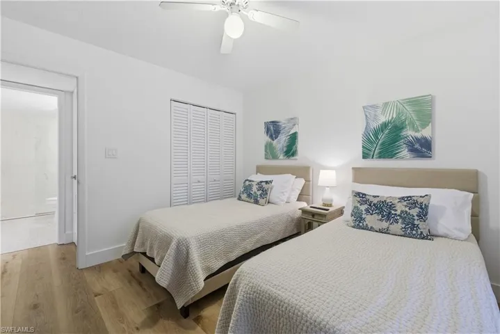 Bedroom with wood finished floors, a closet, and a ceiling fan