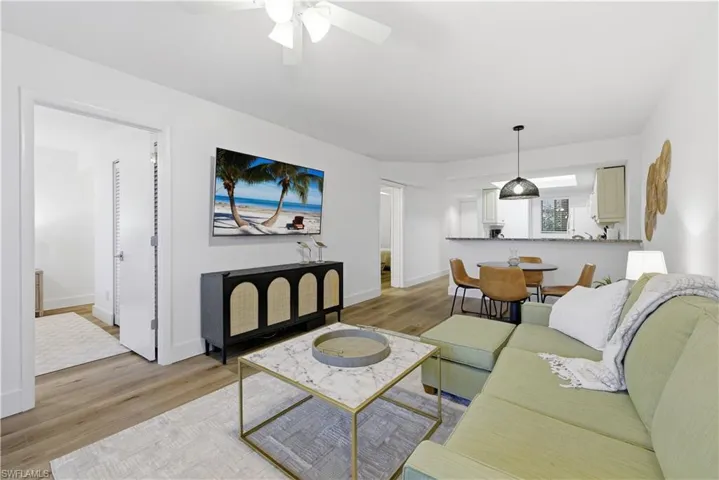 Living room featuring light wood-style flooring and ceiling fan