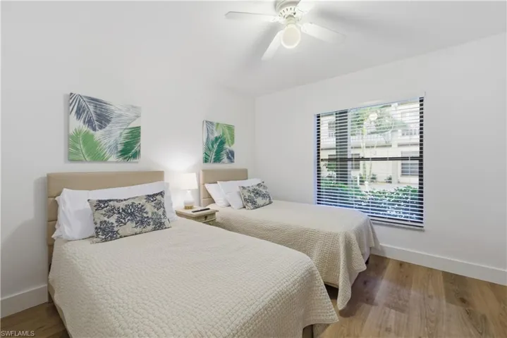 Bedroom with wood finished floors and ceiling fan