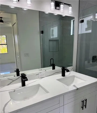 Bathroom with a shower stall and double vanity