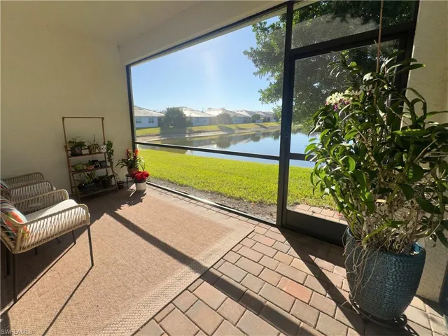 Sunroom with a water view and a residential view
