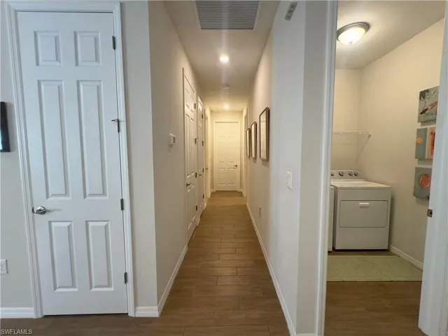 Corridor with washer / clothes dryer, dark wood-style floors, and recessed lighting