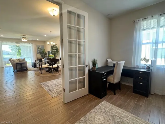 Office area featuring wood tiled floors and ceiling fan