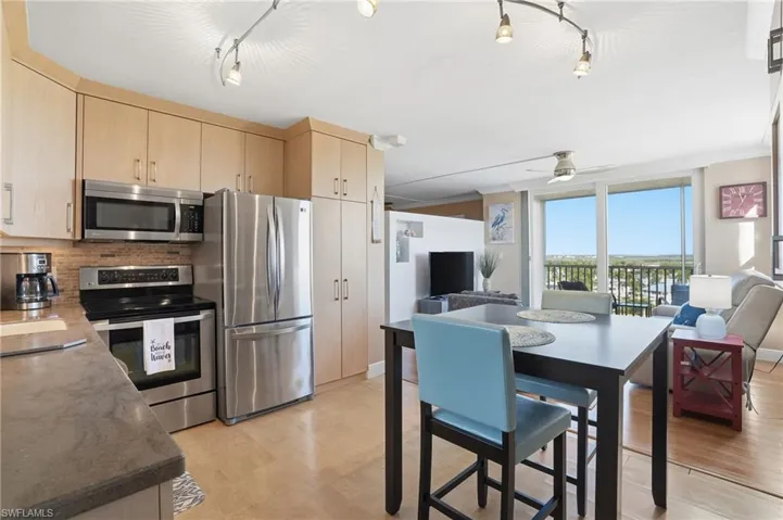 Fully Updated Kitchen with Stackable Washer and Dryer in cabinet next to Fridge