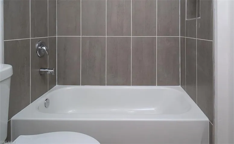 Full bathroom with toilet and bathtub / shower combination