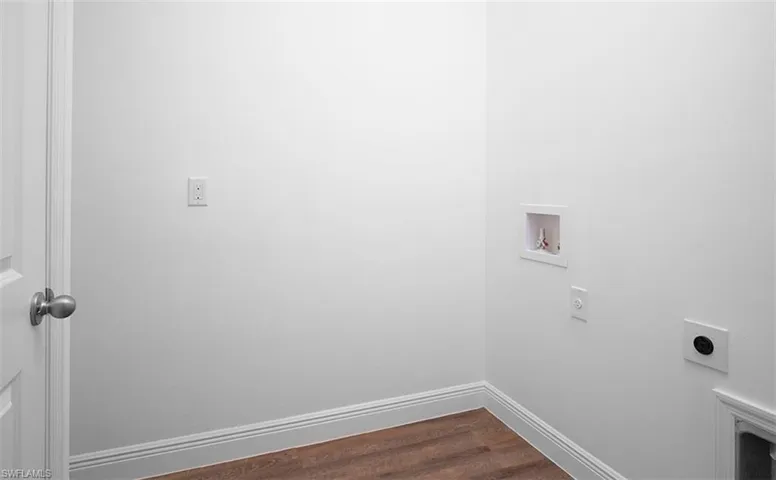 Laundry room with dark wood-style flooring, hookup for a washing machine, and electric dryer hookup