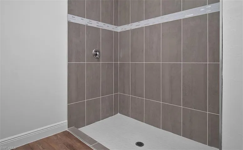 Bathroom featuring a stall shower and wood finished floors