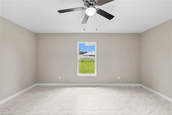 Unfurnished room with light marble finish flooring and baseboards