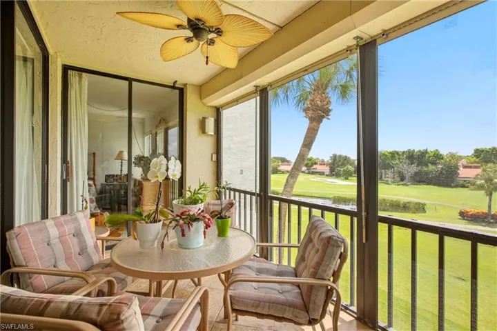 Screened balcony with ceiling fan and direct golf course frontage