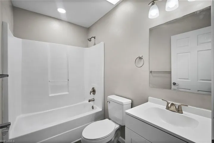 Full bathroom with vanity, toilet, and bathing tub / shower combination