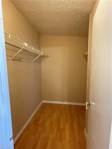 Primary bedroom walk in closet