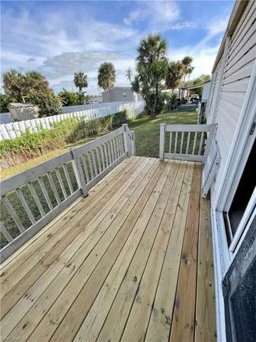 New wooden deck with access to fenced in yard