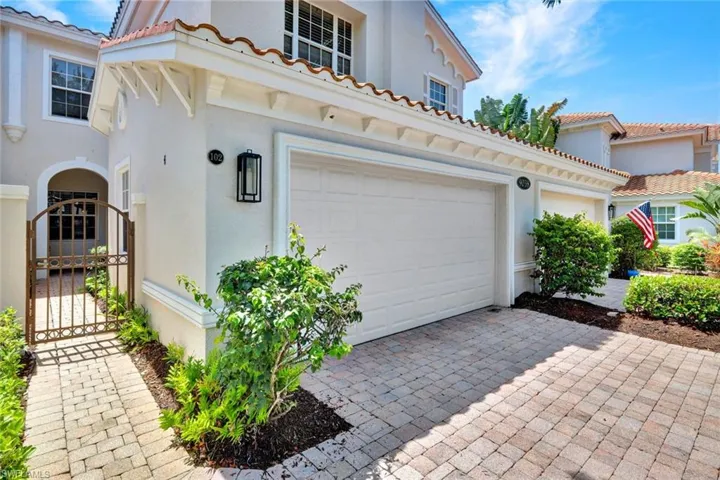 Stucco exterior featuring a tile roof and decorative corbels