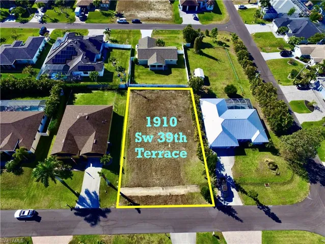 Aerial perspective of suburban area featuring property boundaries highlighted
