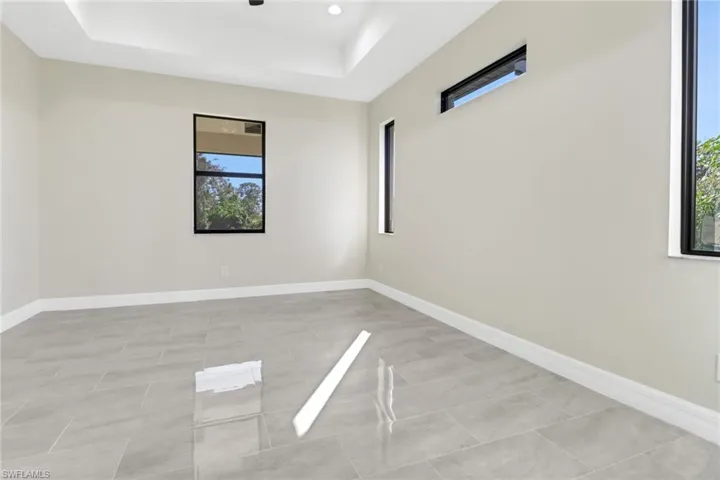 Unfurnished room featuring a raised ceiling