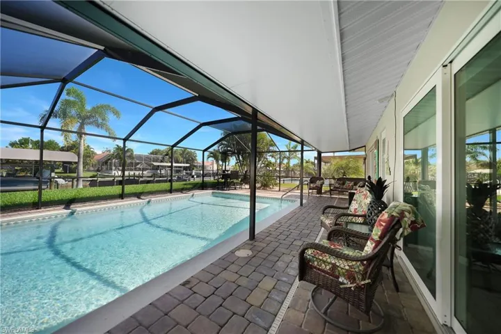Beautiful pavered pool deck and an entertainer's dream shaded dining space