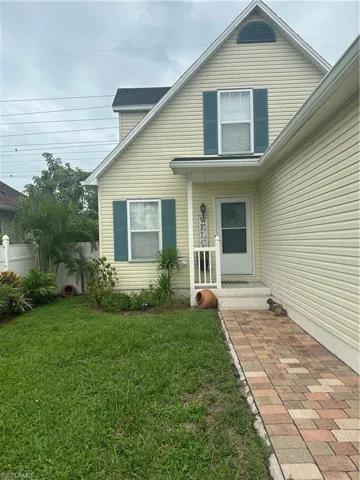Entrance to property with a lawn