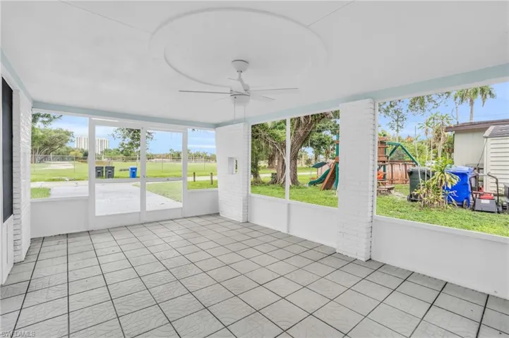 Unfurnished sunroom featuring ceiling fan and plenty of natural light
