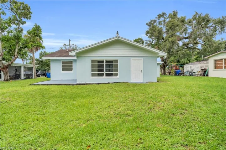 Back of property featuring a lawn