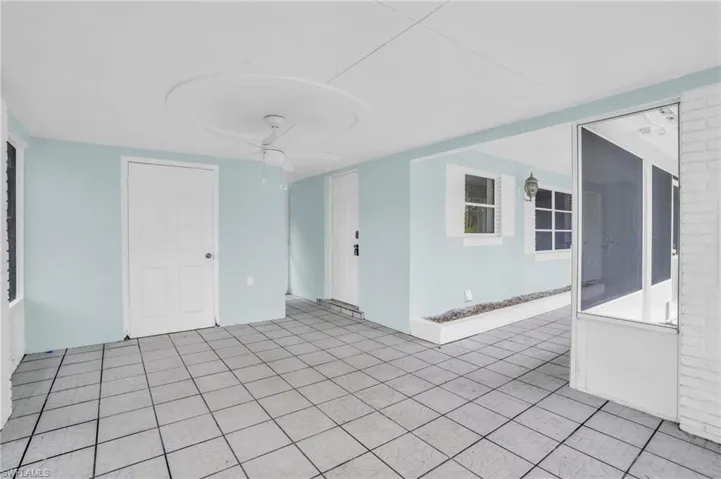Unfurnished room featuring ceiling fan and light tile patterned floors