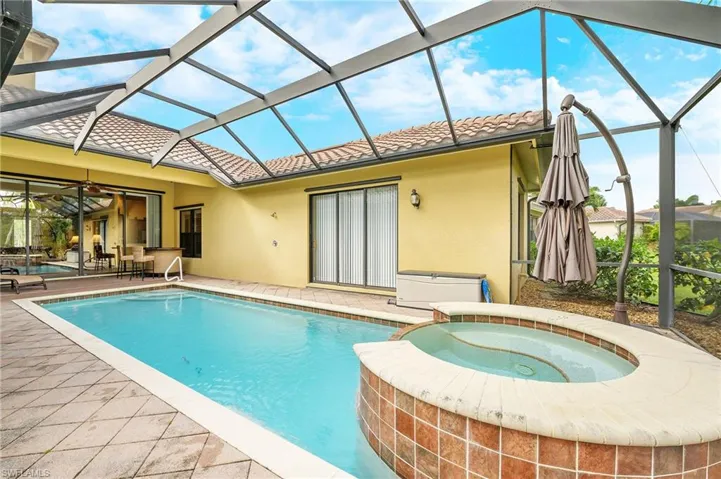 View of pool featuring a patio, a lanai, a pool with connected hot tub, and ceiling fan