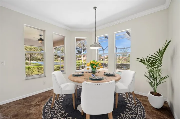 Breakfast Room overlooking the Lanai and Pool area  *Virtually Staged