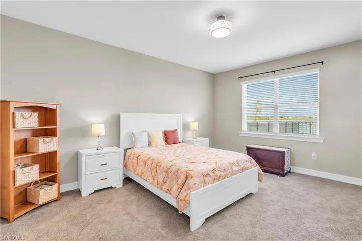 Bedroom featuring light colored carpet