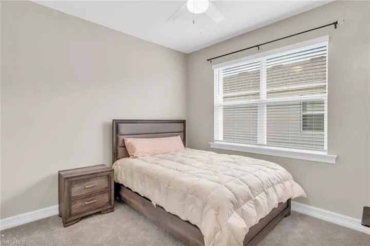Bedroom featuring light carpet and ceiling fan