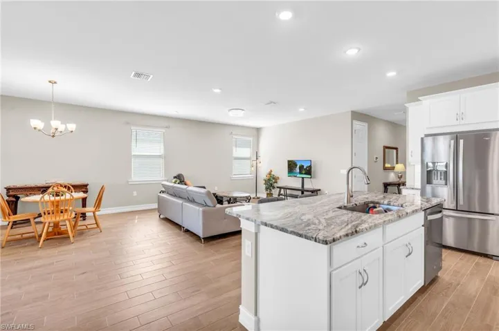 Kitchen featuring white cabinets, a kitchen island with sink, light hardwood / wood-style flooring, sink, and stainless steel appliances