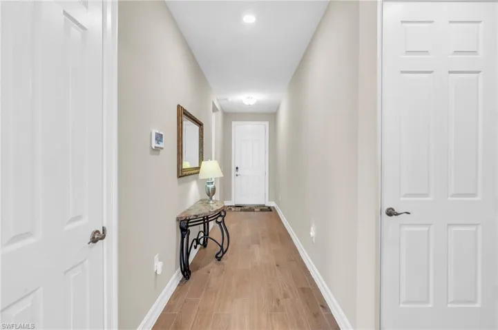 Hall with light hardwood / wood-style flooring