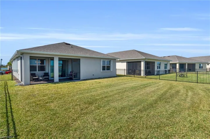 Back of property featuring a patio and a lawn
