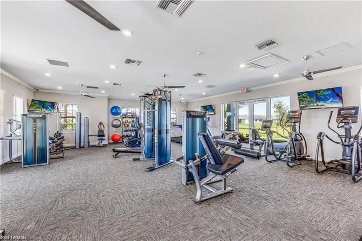 Gym with light carpet and ornamental molding