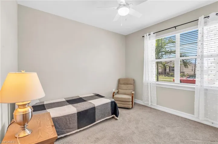 Carpeted bedroom with ceiling fan