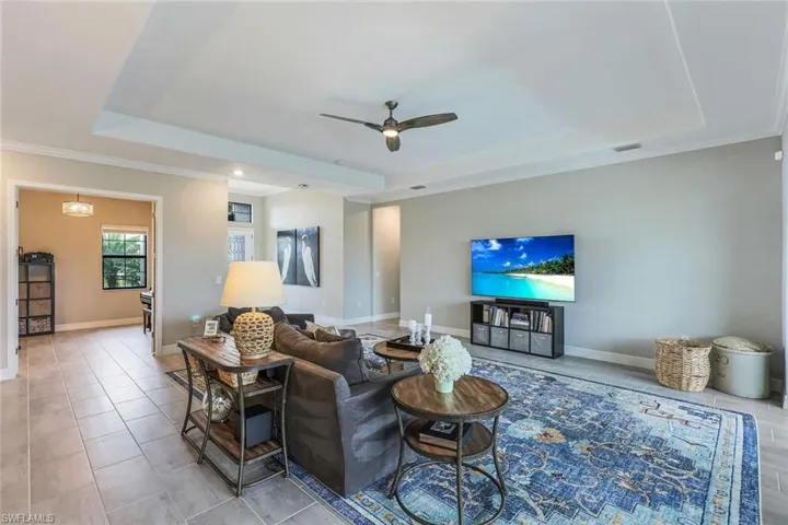 Additional views of the living space and adjacent Den/Office with glass doors.