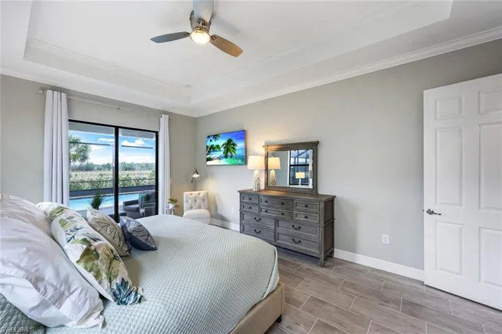 SPACIOUS Owner's Suite offers view of the preserve and offers Pool/Lanai access from the sliding glass patio door.