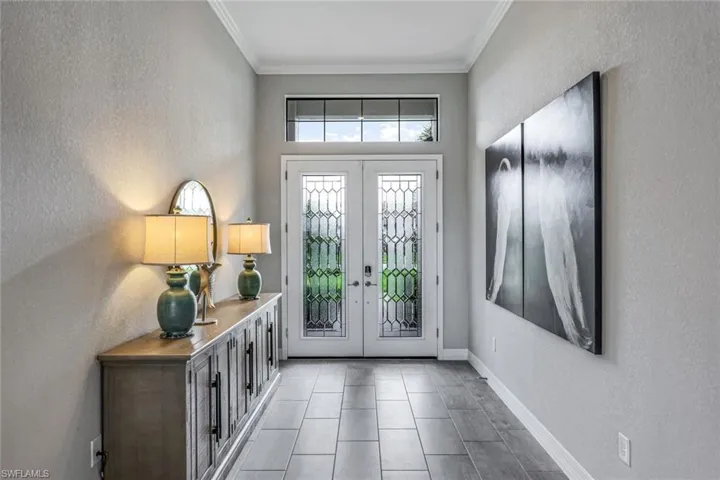 Grand home Foyer with glass inserts to allow for extra light.