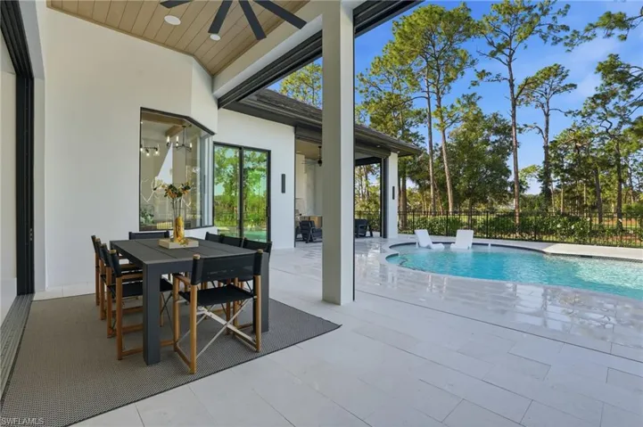 View of pool with outdoor dining space and a patio area