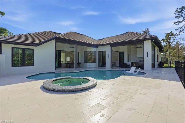 View of pool featuring a pool with connected hot tub and a patio area