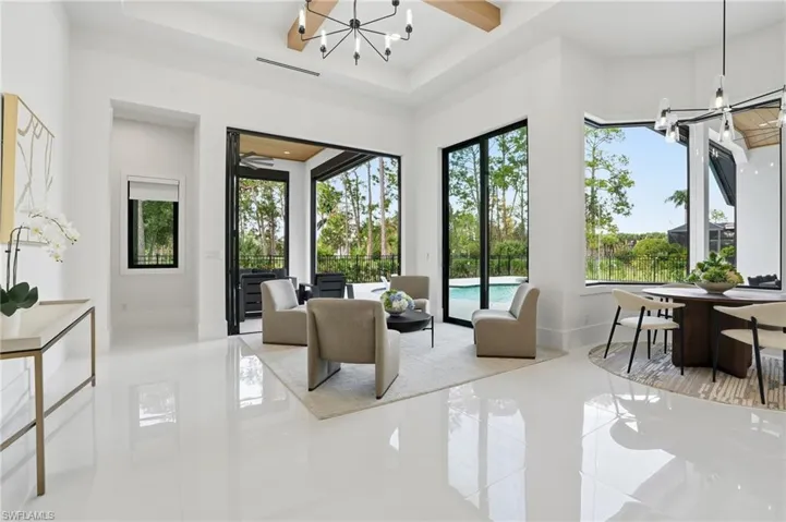 Living room featuring a chandelier and baseboards