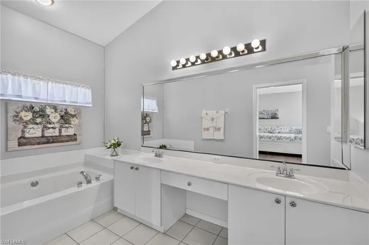 Primary Bathroom with dual sinks, vanity, and soaking tub.
