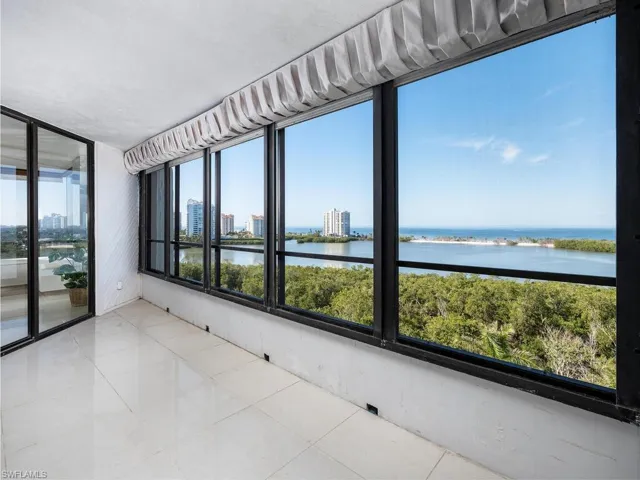 Unfurnished sunroom featuring a water view