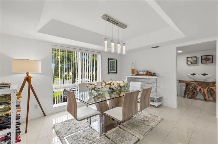 Dining space featuring, a healthy amount of sunlight, and a tray ceiling