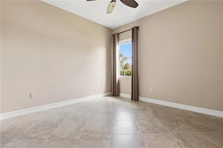 Spare room with baseboards and ceiling fan