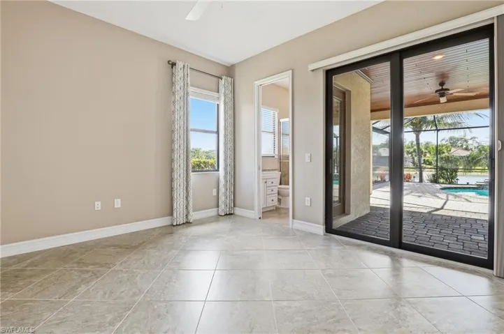 Empty room with ceiling fan and a sunroom