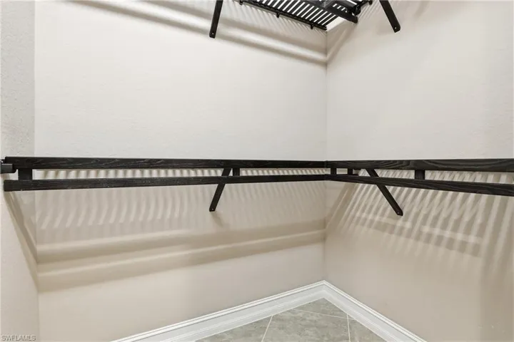 Spacious closet featuring light tile patterned flooring