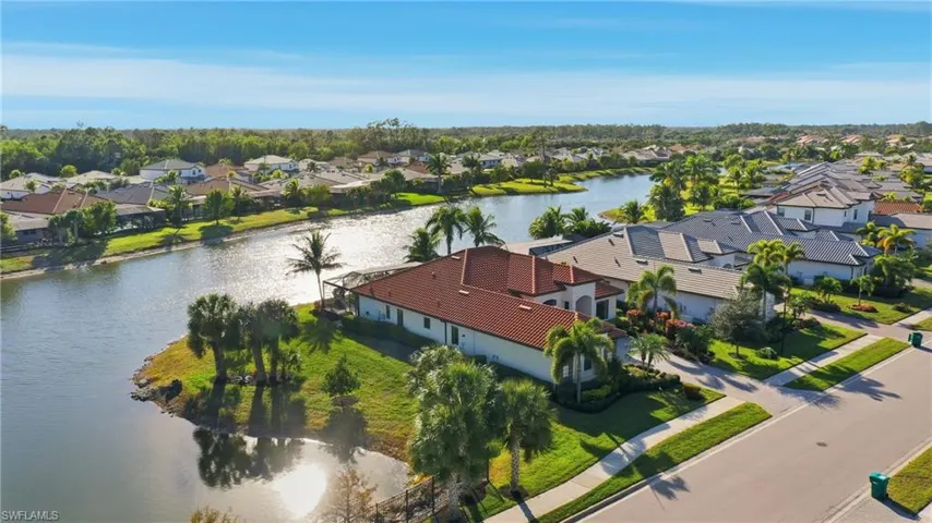Aerial perspective of suburban area with a nearby body of water