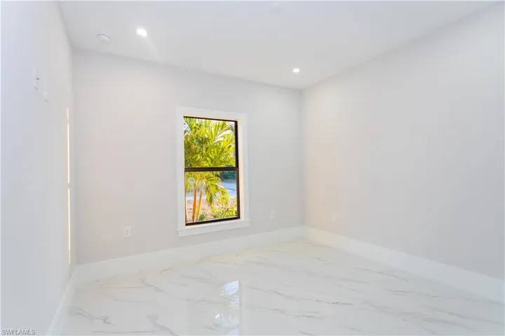 Unfurnished room featuring light marble finish flooring and recessed lighting