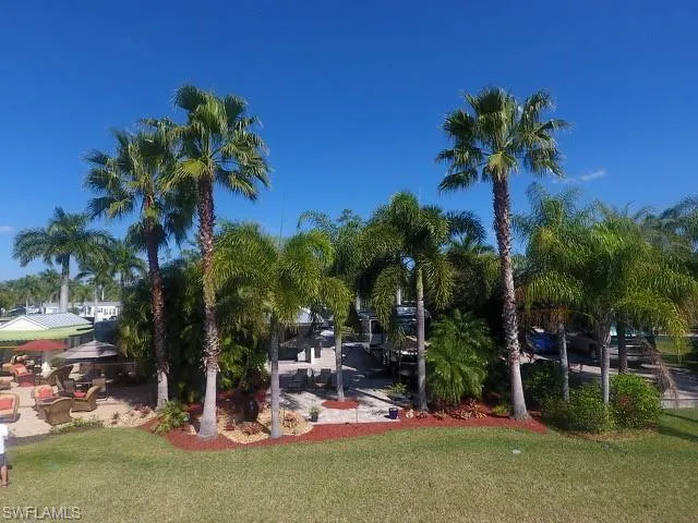 View of property's community with a patio area and a lawn