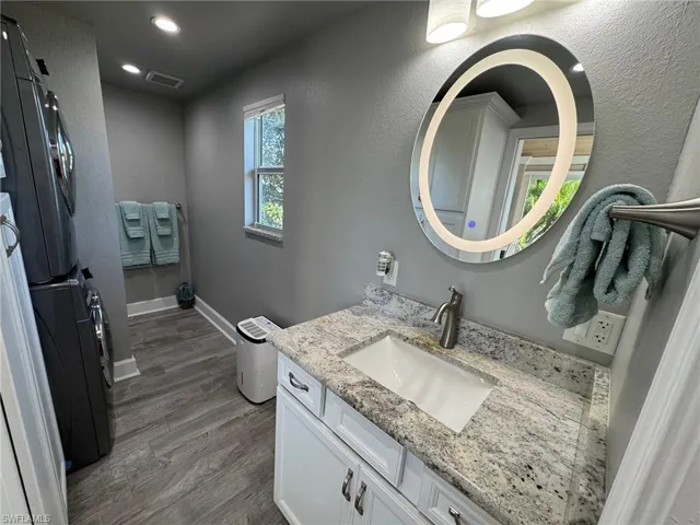 Bathroom featuring vanity and wood-type flooring