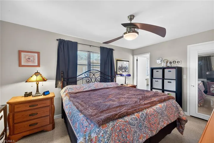 Bedroom featuring light carpet and a ceiling fan